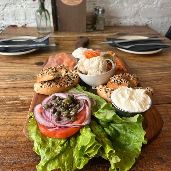 A Wicked Sisters bagel and lox platter with cream cheese, capers, onions, and pickled vegetables.